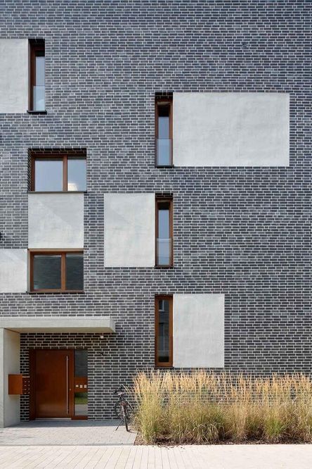 A grey building in staggered stretcher bond bricks.